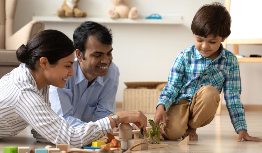 child playing with parents on the floor