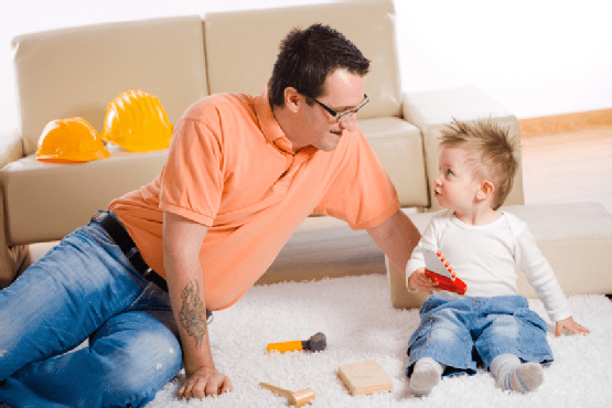 Father and Son Playing Together at Home Father and Son Playing Together at Home