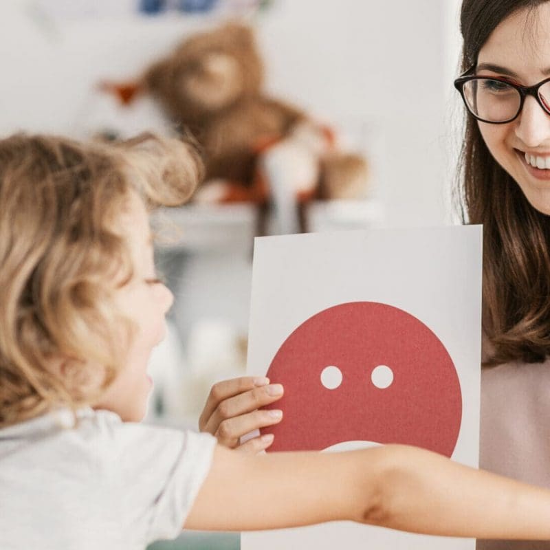Emotion emoticons used by a psychologist during a therapy session with a child with an autism spectrum disorder.